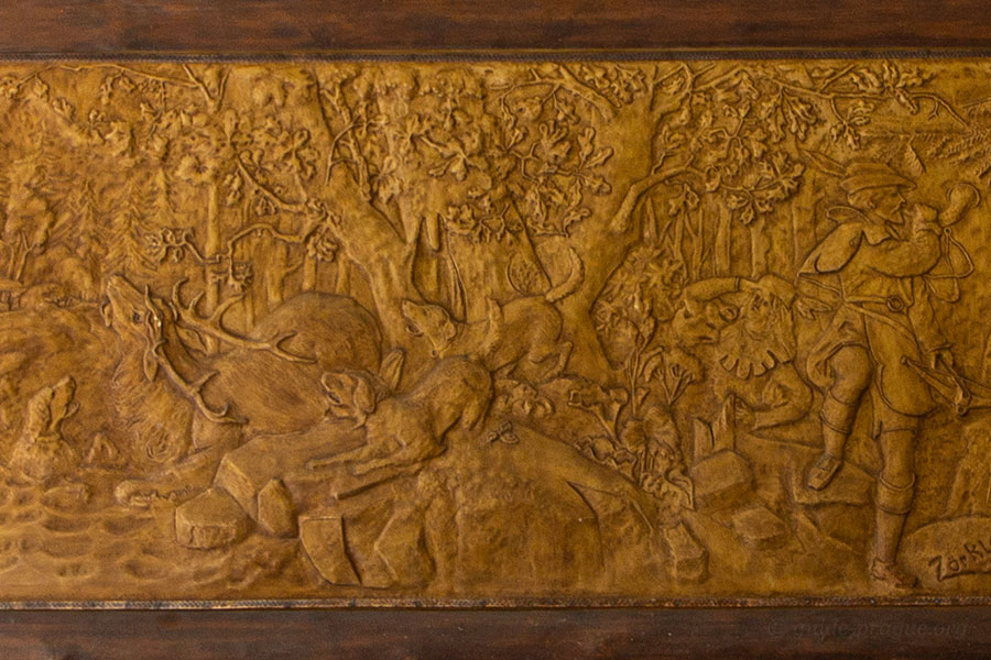 Photo of the relief depicting the legend of the foundation of Karlovy Vary in the Market Colannade.