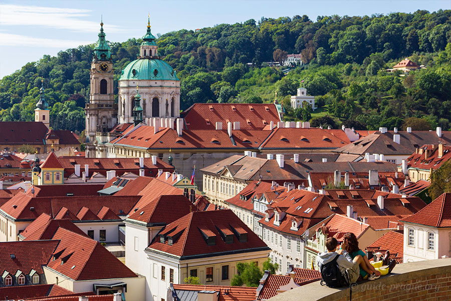 Photo of St. Nikolas Church and red tile roofs of the Lesser Town